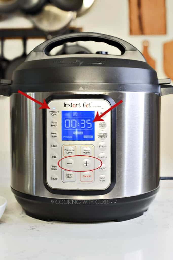 Instant Pot set for 35 minutes on HIGH pressure with red arrows to show important buttons, and a circle around the + and - buttons. 