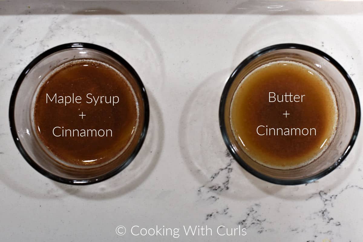 A small bowl of maple syrup and cinnamon next to a small bowl of melted butter and cinnamon. 