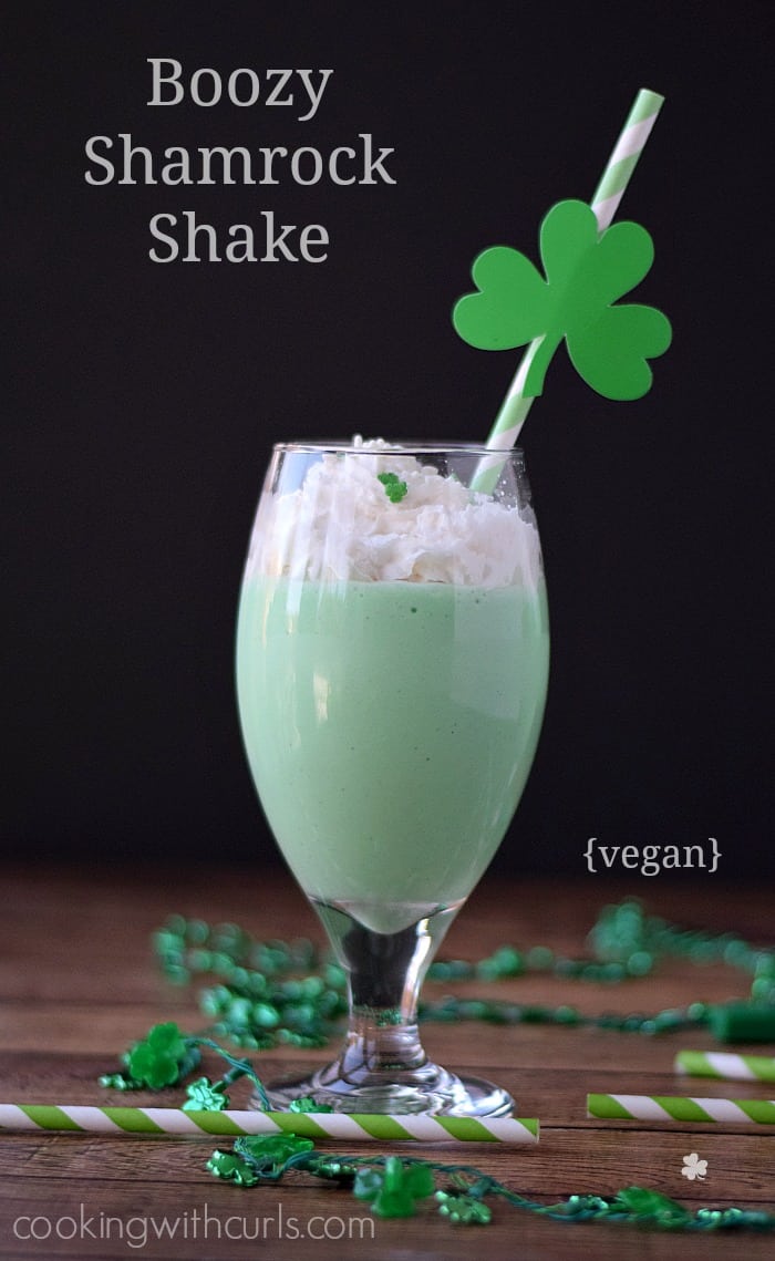 Vegan Boozy Shamrock Shake topped with whipped coconut cream and shamrock sprinkles. 