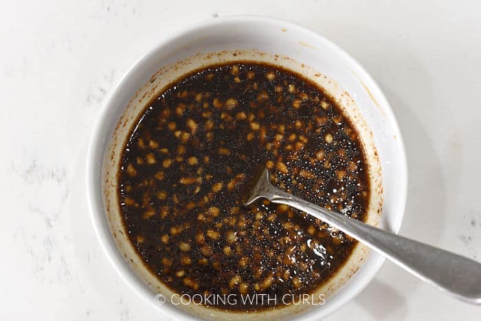 Adobo sauce mixed in a small bowl with a fork. 