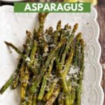 Asparagus spears topped with lemon zest and parmesan cheese laying on a white platter with title graphic across the top