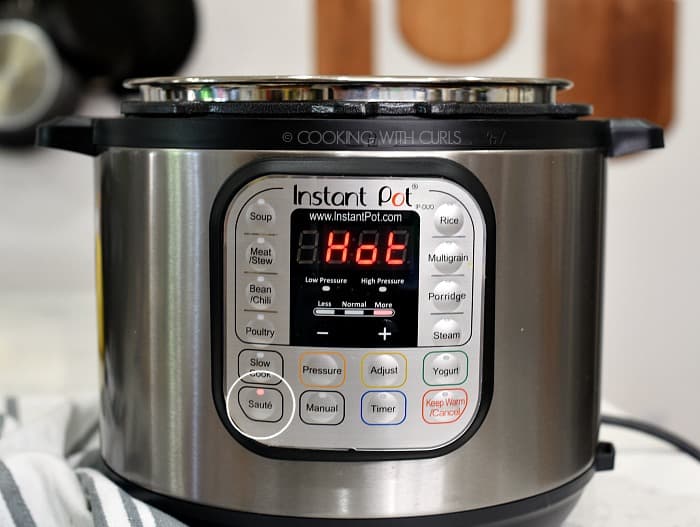 An Instant Pot set the Saute with HOT in bright red letters on the display 