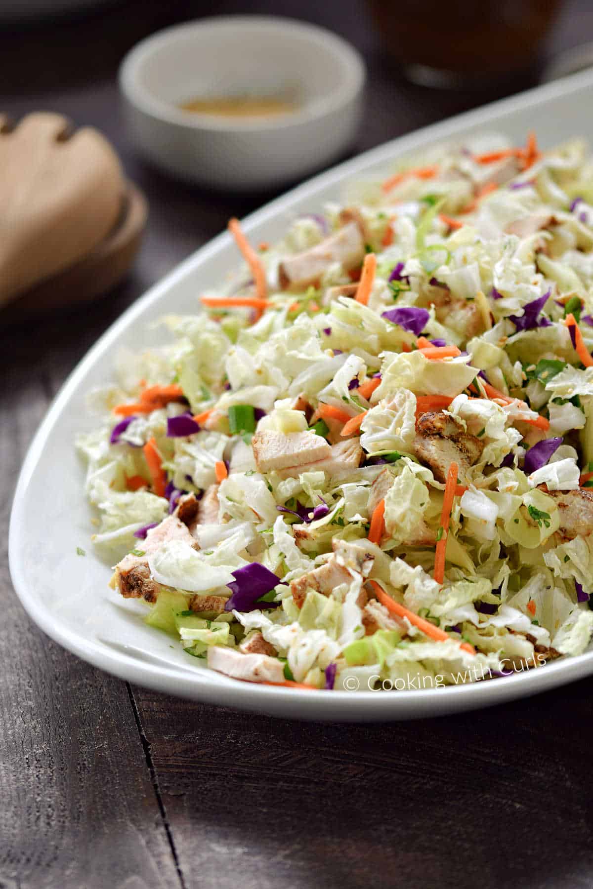 Asian Sesame Chicken Salad in an oval serving bowl.