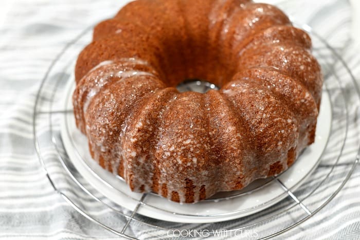 Bacardi Pina Colada Rum Cake on a wire rack with glaze poured over the top. 