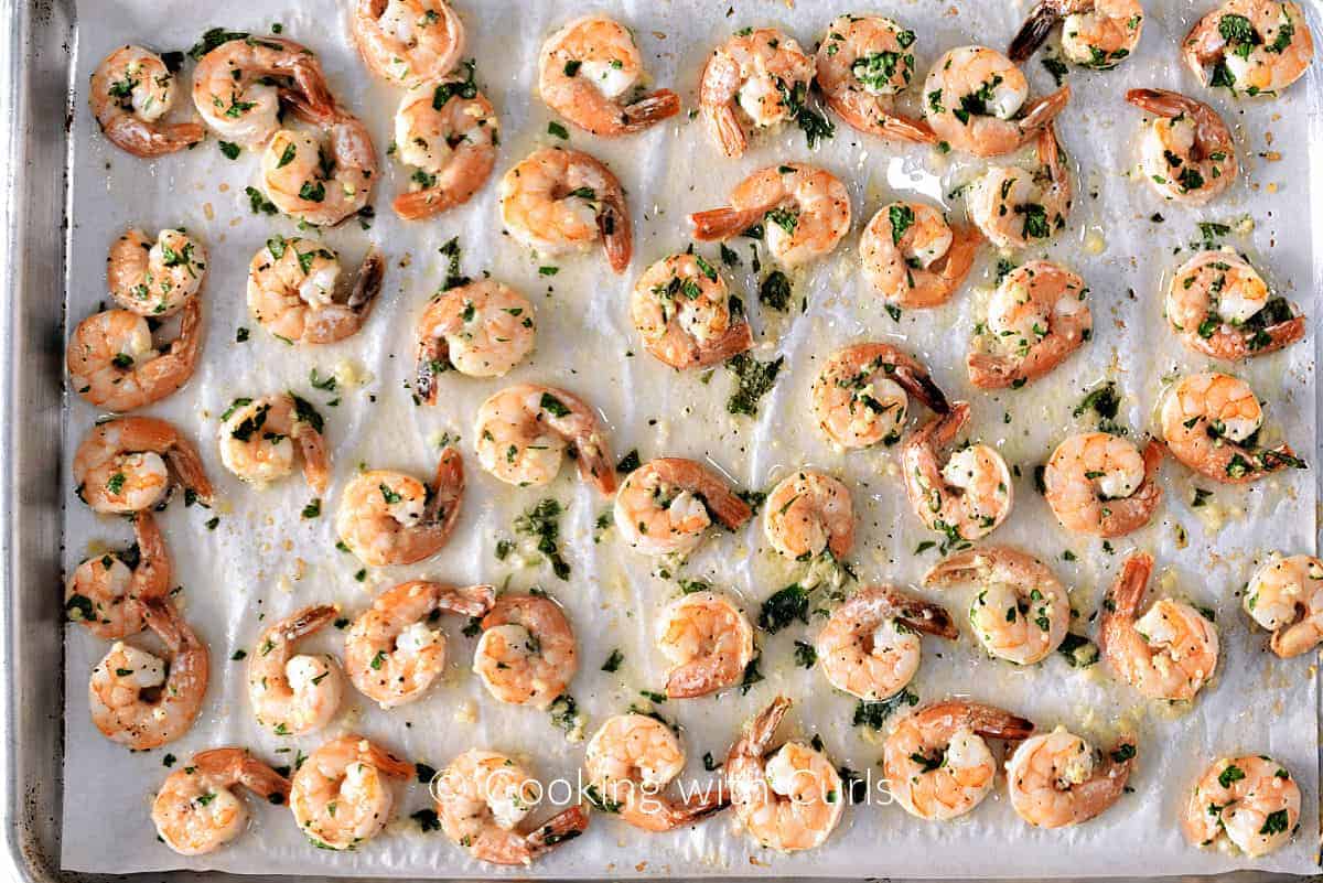 Baked Garlic Lemon Shrimp on a parchment lined baking sheet. 