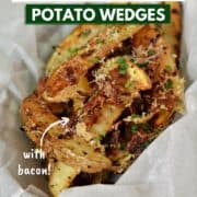 Baked potato wedges topped with Parmesan cheese, bacon, and herbs in a parchment lined basket with title graphic across the top.