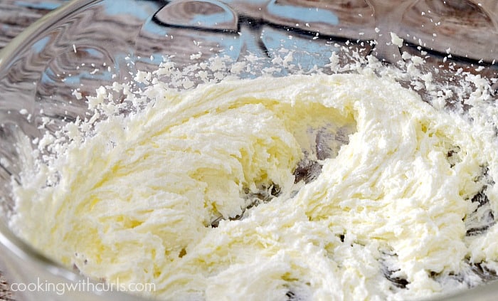 Sugar and butter whipped in a large glass bowl.