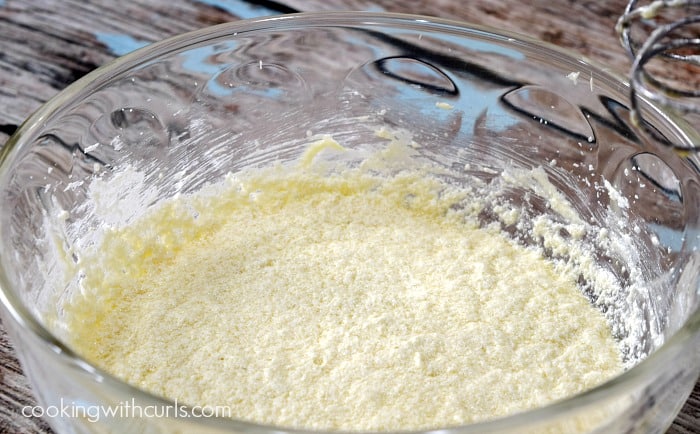 Butter, sugar, and eggs beaten together in a large glass bowl.