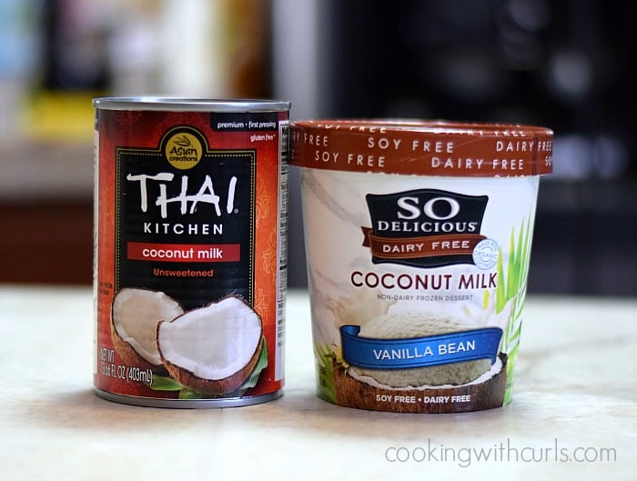 A can of coconut milk sitting next to a pint of coconut milk ice cream.