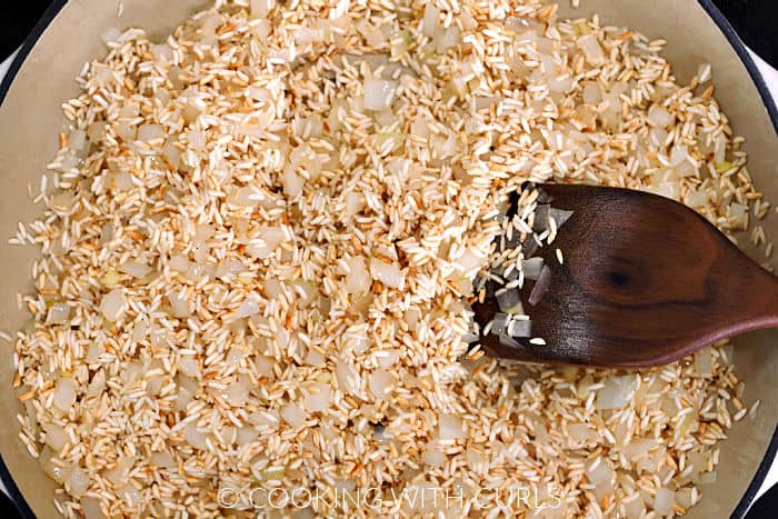 Browned rice and chopped onions in a large skillet. 