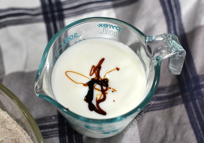 Buttermilk and molasses in a glass measuring cup. 