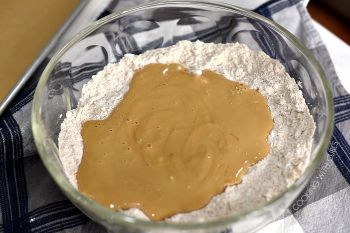 Buttermilk molasses mixture poured into the center of the dry ingredients in a large bowl. 
