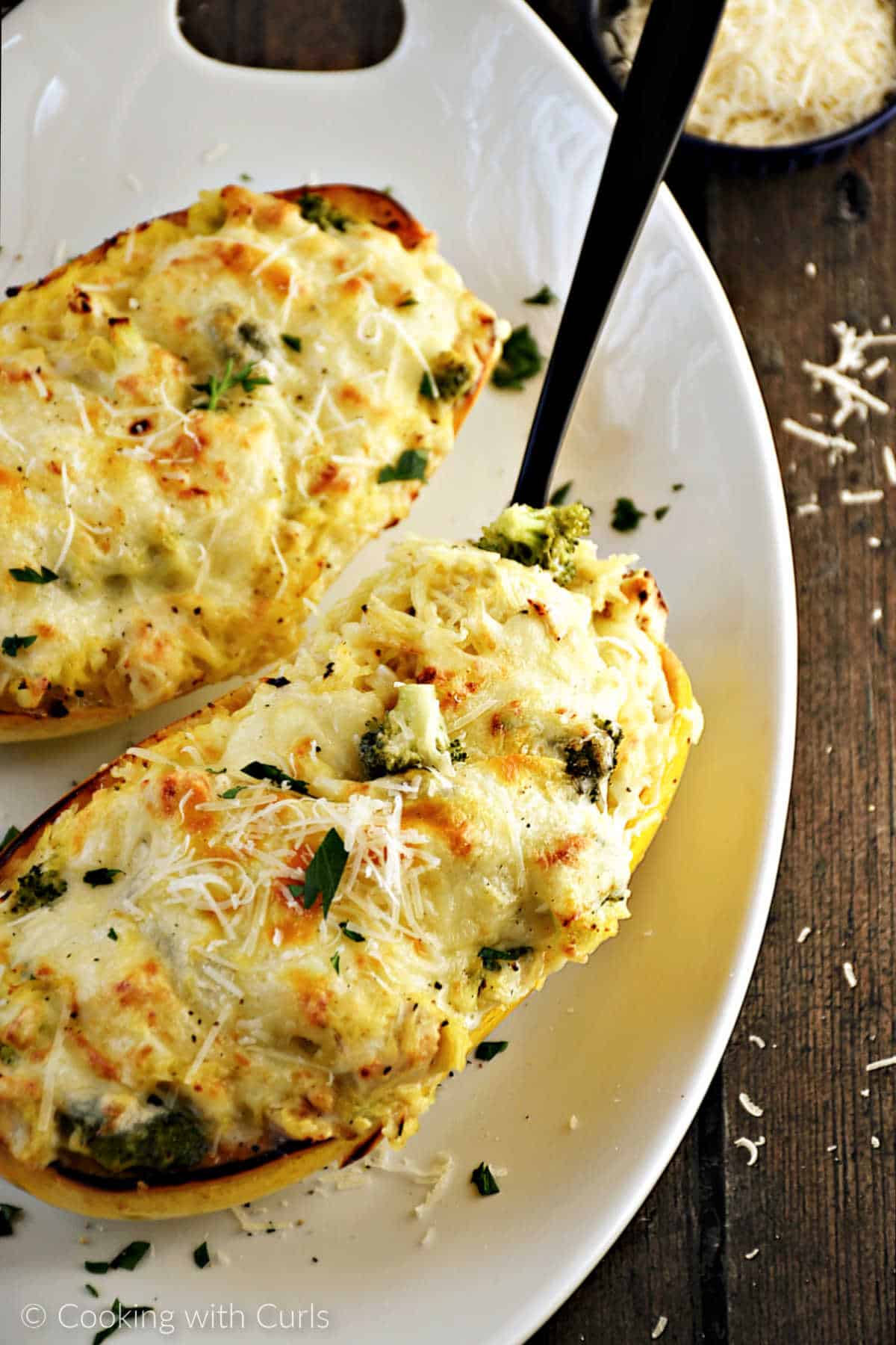 Chicken alfredo spaghetti squash halves on a serving platter.