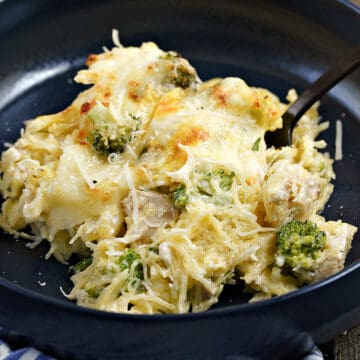 Chicken Alfredo Spaghetti Squash with broccoli and melted cheese in a bowl.