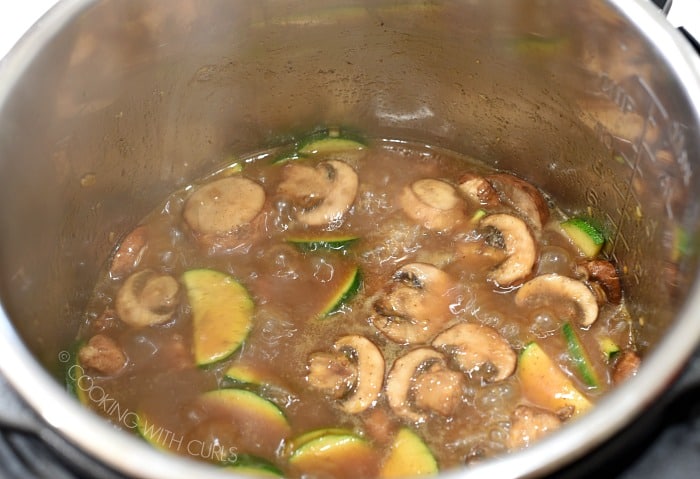 Chinese Garlic Chicken simmering in the metal liner of a pressure cooker 