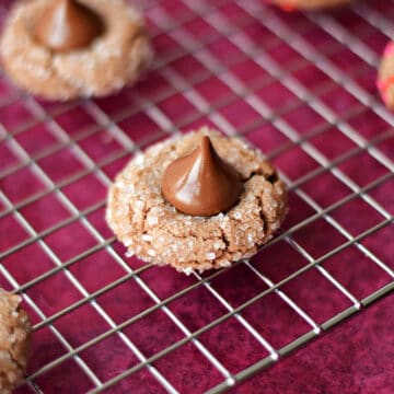 Chocolate Peanut Butter Blossom Cookies on a wire cooling rack.