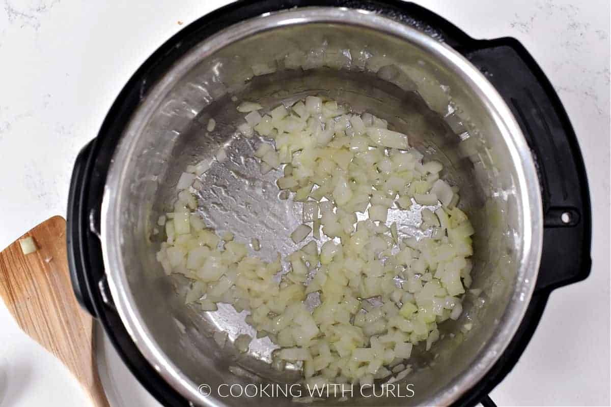 Chopped onion and oil in a pressure cooker. 