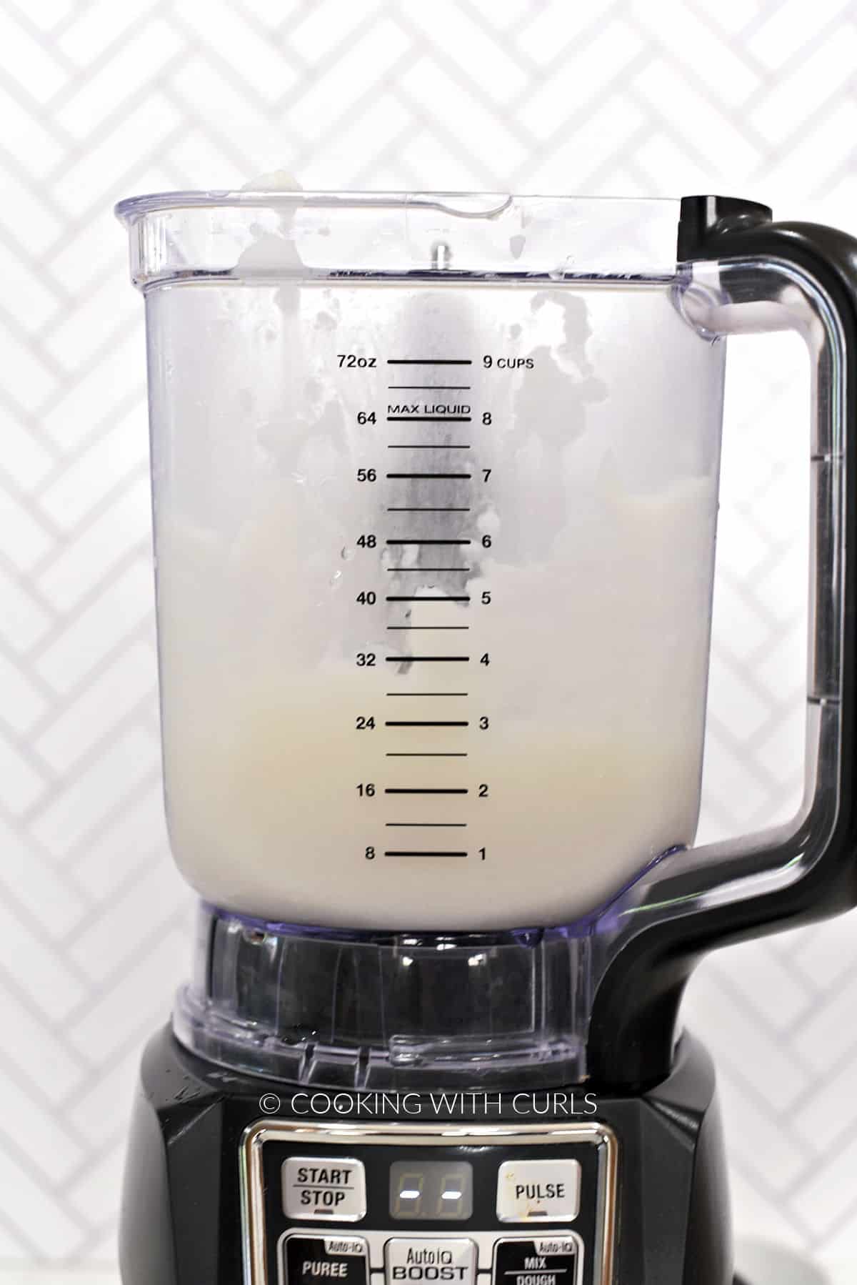 Coconut milk, cream, rum, and pineapple juice blended together in a blender. 