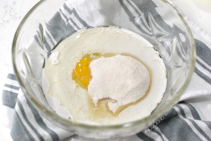 Coconut milk, oil, eggs and sugar in a large glass bowl. 