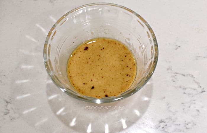 cornstarch mixed with cooking liquid in a small glass bowl. 