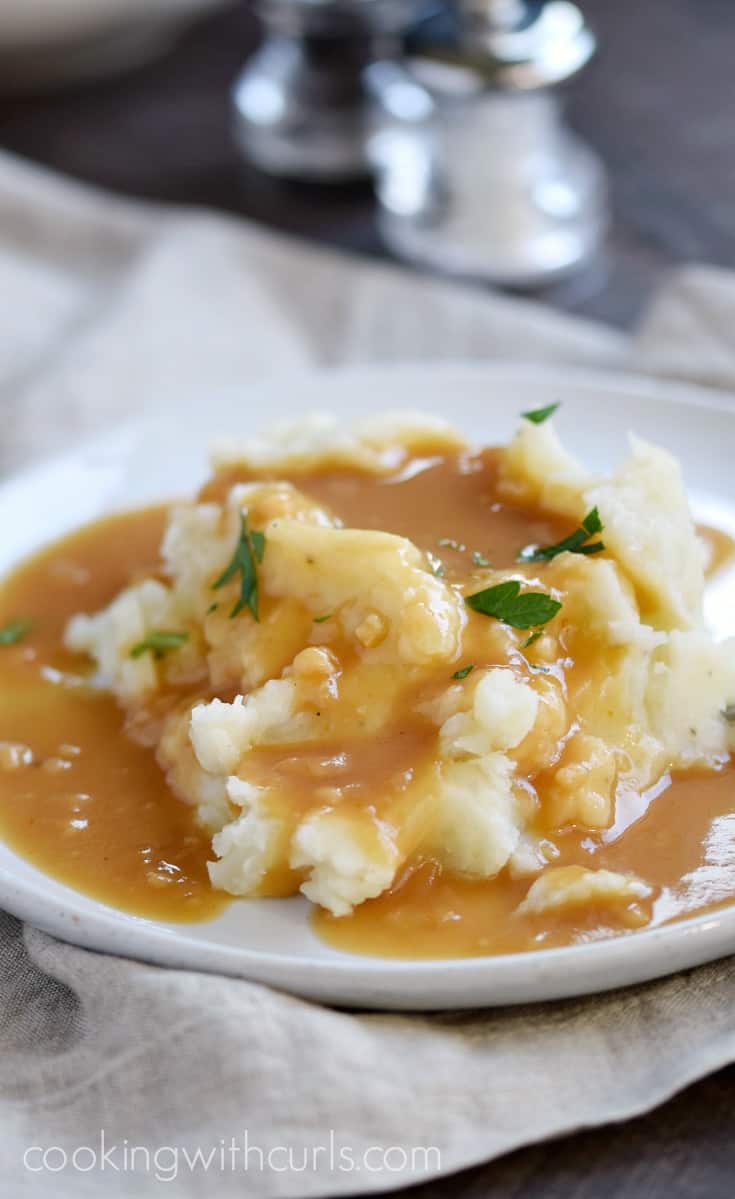 Creamy and fluffy Instant Pot Mashed Potatoes topped with savory beef gravy | cookingwithcurls.com