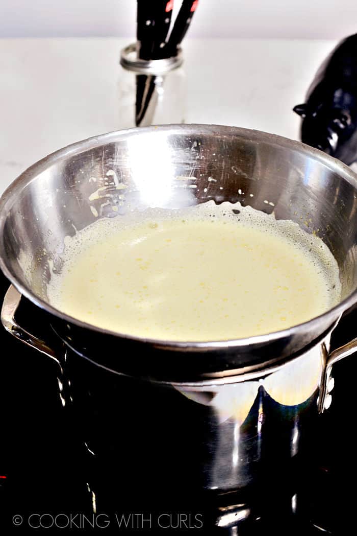 Creme Brulee mixture in a double boiler on the stove.