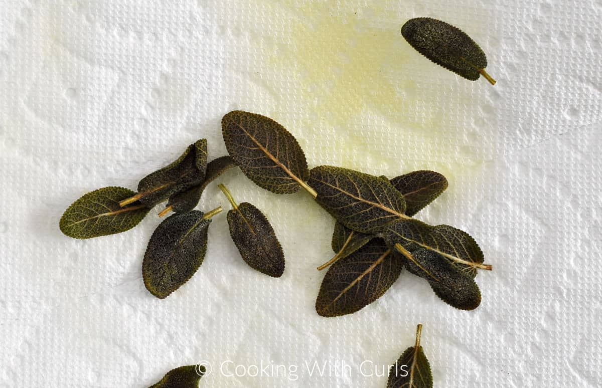 Crispy fried sage leaves on a paper towel. 