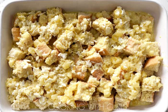 Custard mixture poured over the bread cubes in the baking dish. 