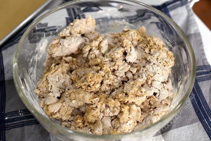 Dry and wet ingredients mixed together in a large glass bowl. 