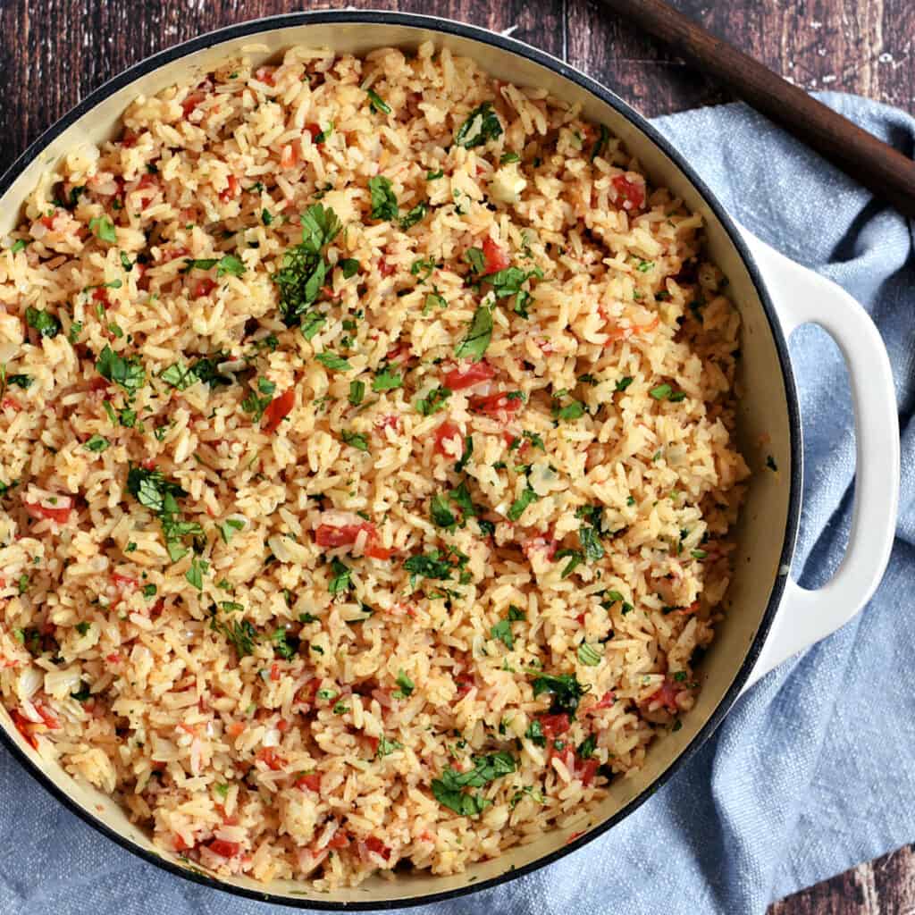 Mexican rice in a white cast iron skillet.