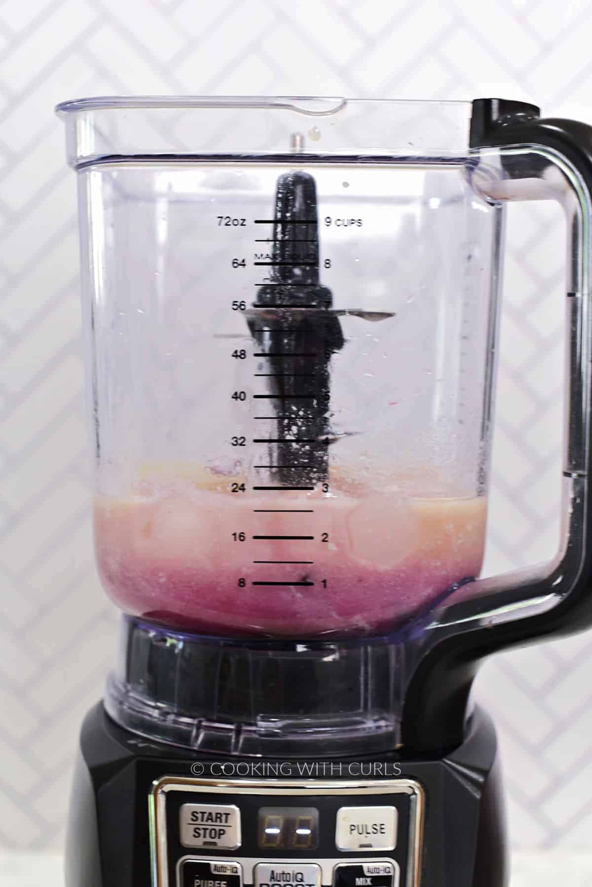 Fresh cherries, pineapple juice, coconut cream, heavy cream, ice cubes, and cherry syrup in a blender. 