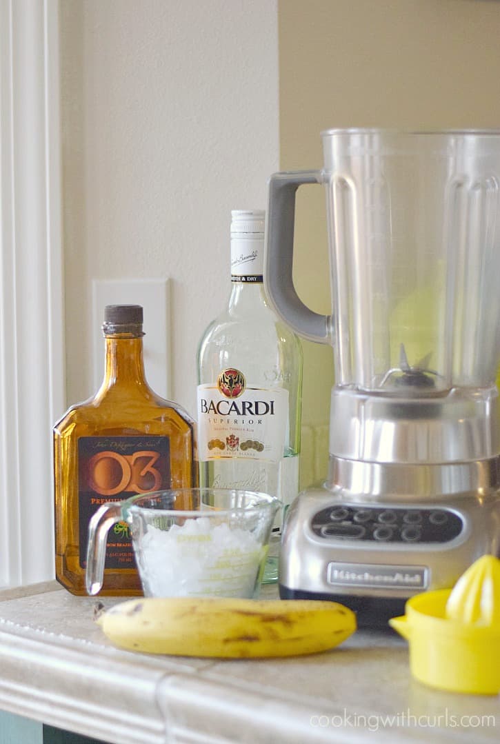 Image of orange liqueur, Bacardi rum, a banana, and empty blender.
