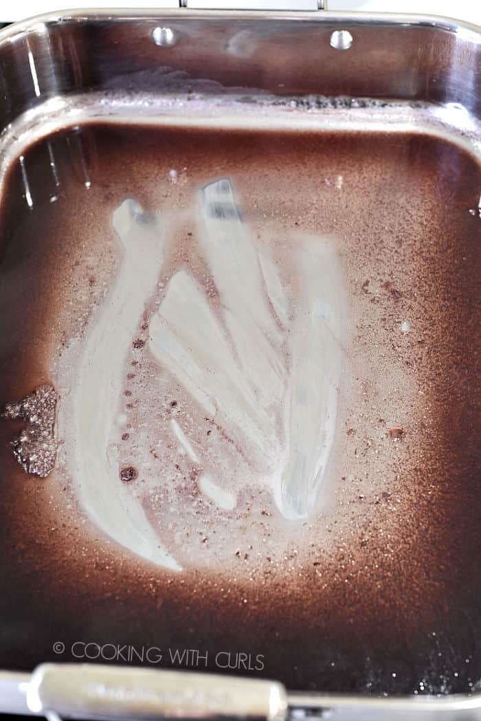 Gravy simmering in the roasting pan. 