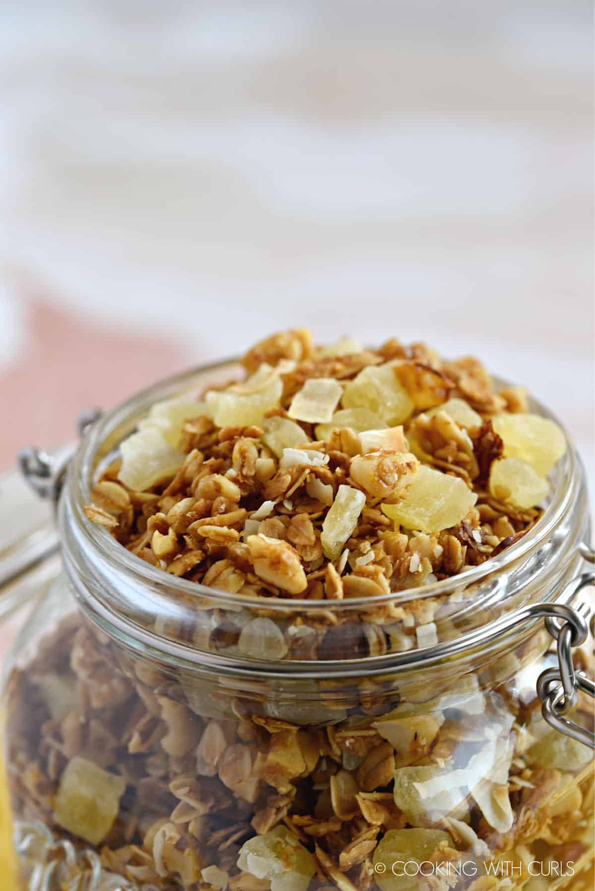 a close up image of Pina Colada Granola in a mason jar.