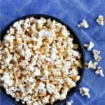 A bowl of popcorn on a blue tile background with title graphic across the top.