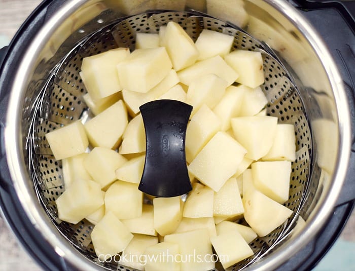 Potato chunks in a steamer basket.