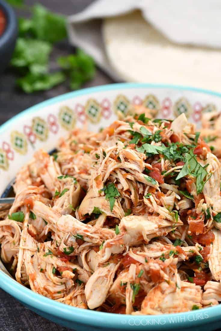 Instant Pot Salsa Chicken in a large bowl topped with chopped cilantro.