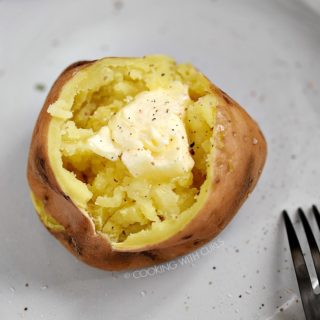 looking down on a Sweet Potatoes topped with butter, salt and pepper