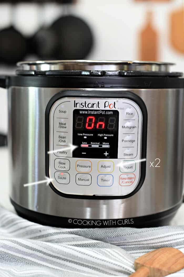 instant pot with white arrows pointing to saute, less and adjust x2. 