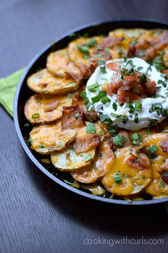 Irish Nachos served in a cast iron skillet sitting on a green napkin