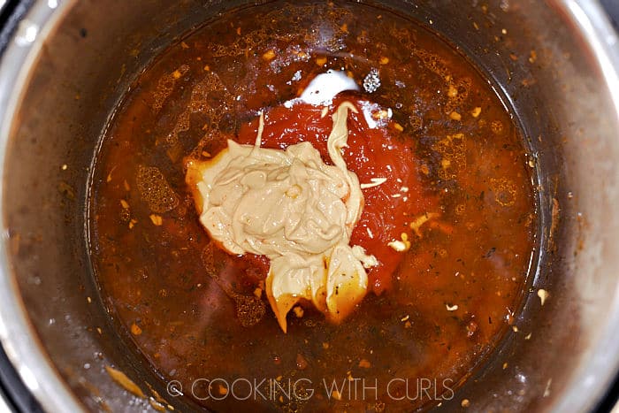 Ketchup and mustard added to the cooking liquid in the pressure cooker. 