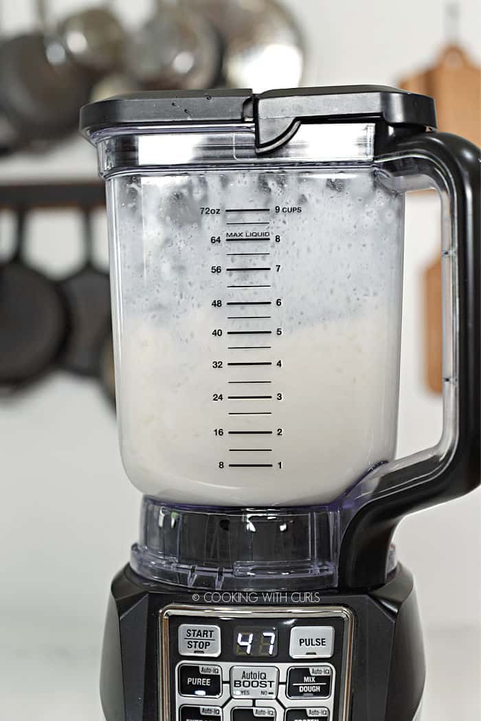 keto pina colada being pureed in a blender. 
