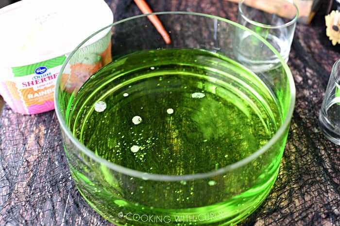 lemon lime soda added to the green food coloring and vodka in the punch bowl.
