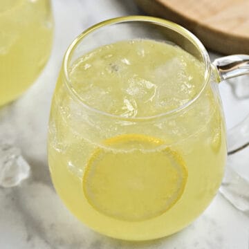 Limoncello Moscow Mule in a glass mug with ice and lemon wheel garnish.