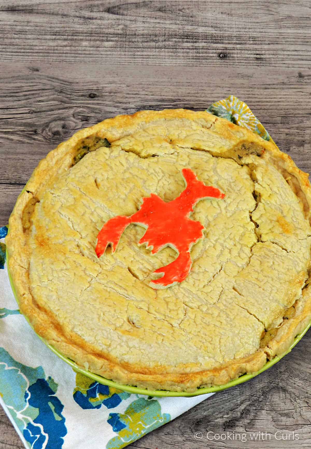 Looking down on a Lobster Pot Pie Pie with a cute red painted lobster cookie on top.