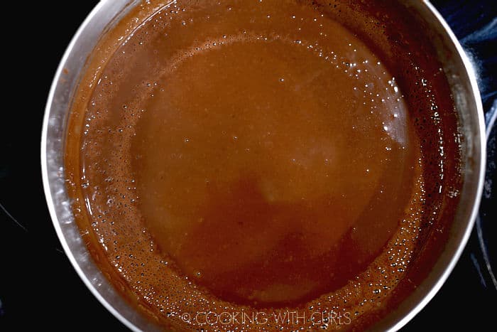 looking down on thickened chocolate gravy in a saucepan. 