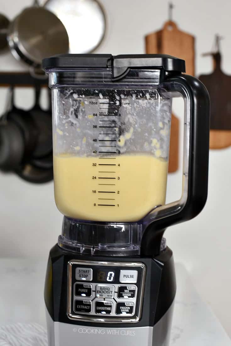 Mango Pina Colada Smoothie being blended in a blender