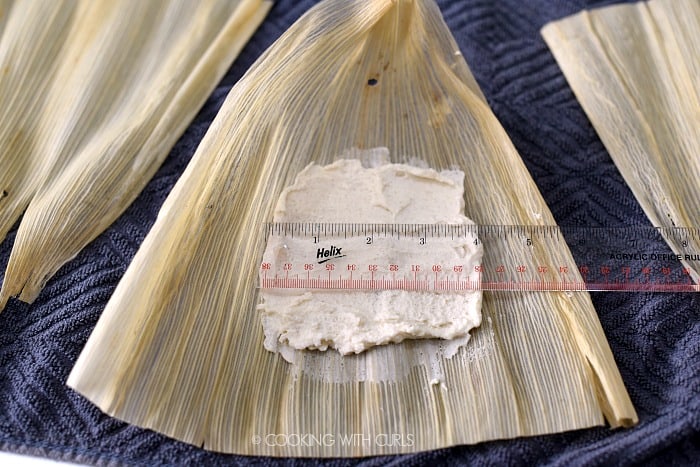 Masa mixture spread onto a corn husk in a 4 inch square. 