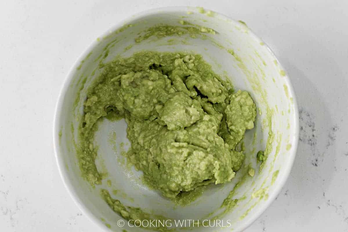 Mashed avocado in a small bowl.