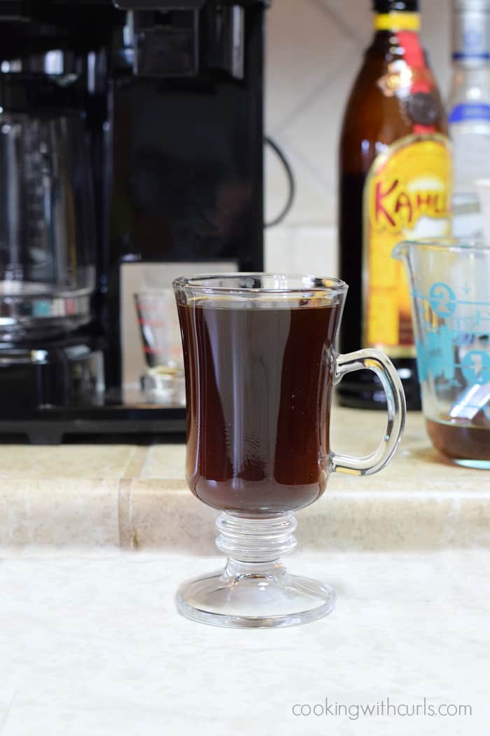 Hot coffee, tequila, and Kahlua in a tall glass mug.
